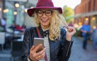 happy woman smiling at search results on smartphone